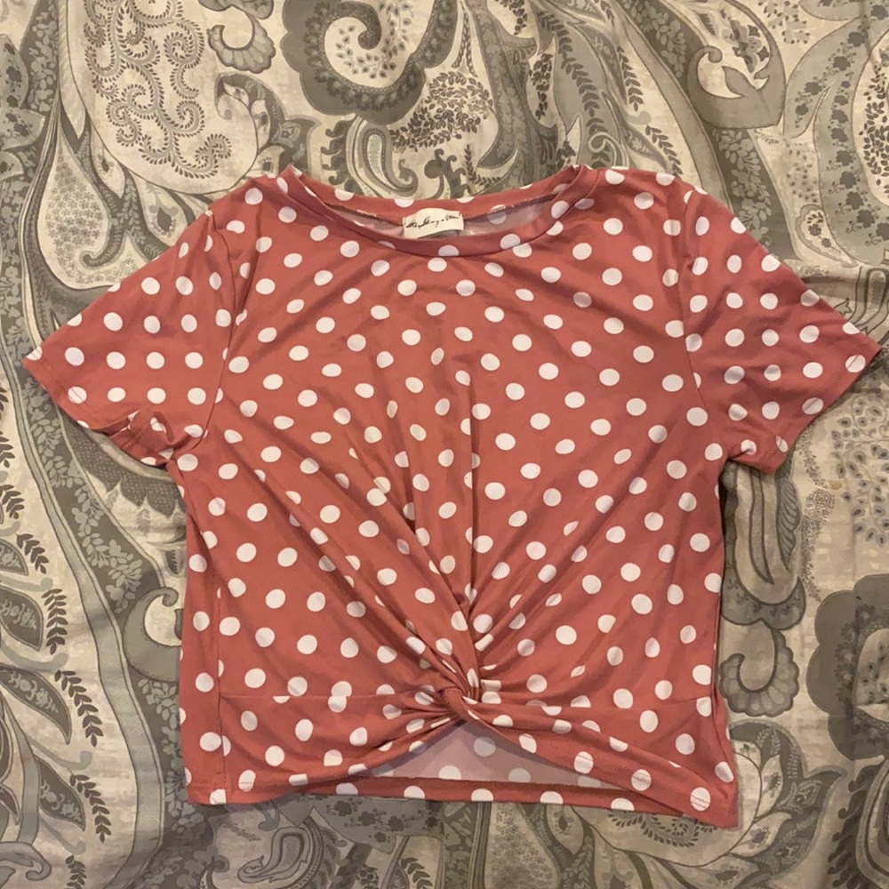 A pink crop top with white pokka dots